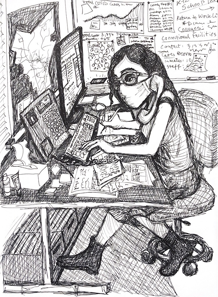 woman in a mask working at a desktop computer, on the phone and taking notes in public health during the COVID-19 pandemic